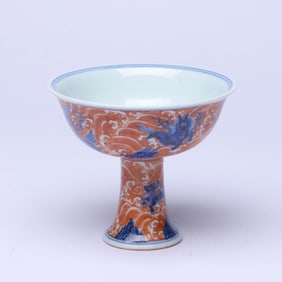A BLUE AND WHITE AND IRON-RED 'WAVES AND DRAGON' STEM CUP