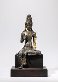 A GILT-BRONZE SEATED FIGURE OF AVALOKITESHVARA