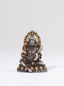 A CHAMPLEVé ENAMEL ON IRON FIGURE OF YELLOW JAMBHALA