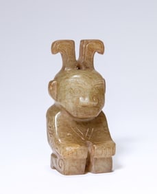 A JADE KNEELING FIGURE