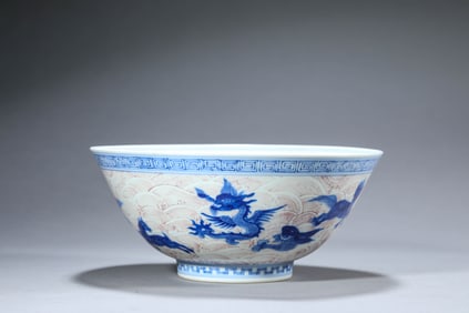 A BLUE AND WHITE AND UNDERGLAZE-RED 'AUSPICIOUS BEAST AMIDST WAVES' BOWL