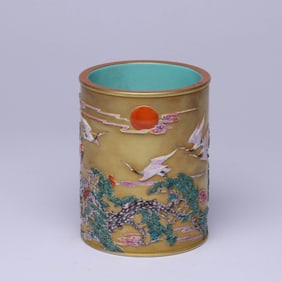 A GOLD-GROUND FAMILLE ROSE 'PINE AND CRANE' BRUSH POT