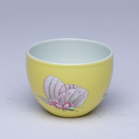 A YELLOW-GROUND FAMILLE ROSE 'BUTTERFLIES' CUP