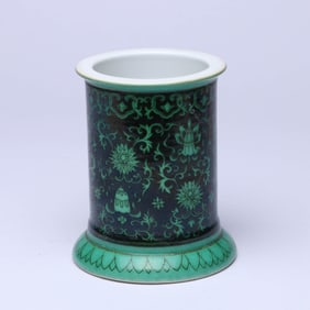 A BLACK-GROUND GREEN 'LOTUS AND EIGHT BUDDHIST EMBLEMS' BRUSH POT