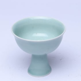 A PALE CELADON GLAZED 'SANSKRIT' STEM CUP