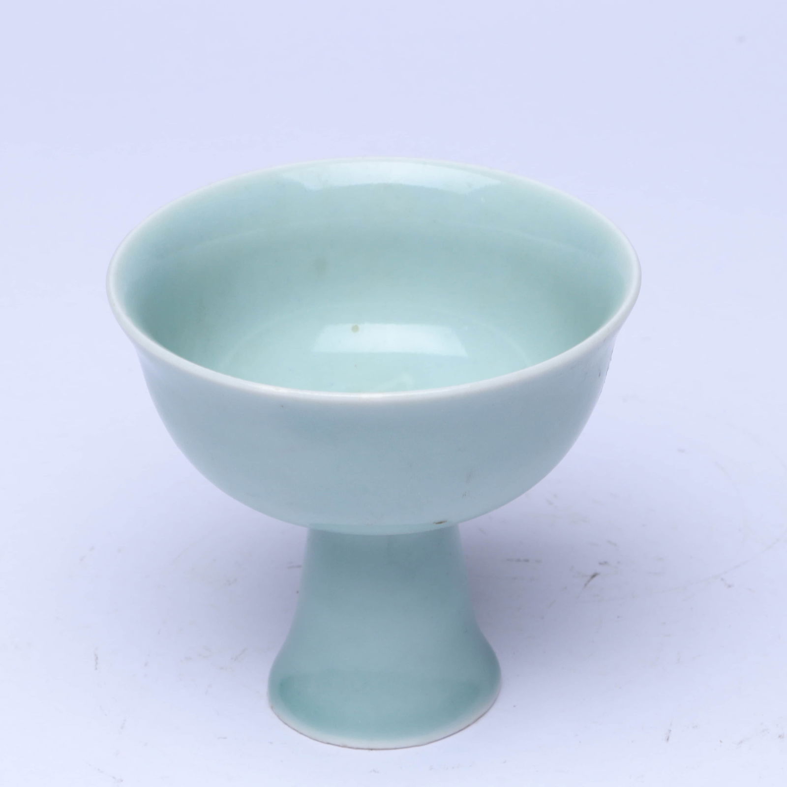 A PALE CELADON GLAZED 'SANSKRIT' STEM CUP: A PALE CELADON GLAZED 'SANSKRIT' STEM CUP Dimensions: Length: 9 cm (3.54 in.), Width: 9 cm (3.54 in.), Height: 8 cm (3.15 in.). All measurements are approximate.