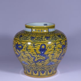 A YELLOW-GROUND BLUE AND WHITE 'CLOUD AND DRAGON' JAR