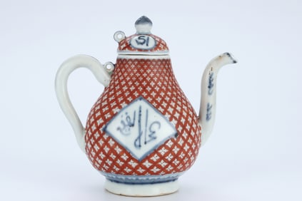 A BLUE AND WHITE AND IRON-RED MEDALLION 'SANSKRIT' PEAR-SHAPED EWER