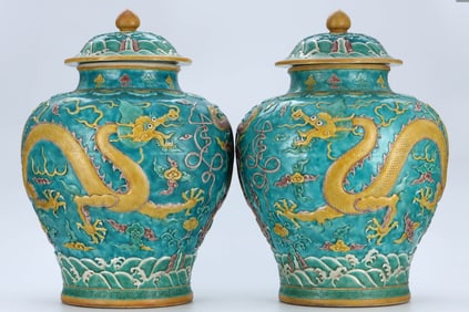 A PAIR OF SANCAI 'WAVES, CLOUD AND DRAGON' COVERED JARS