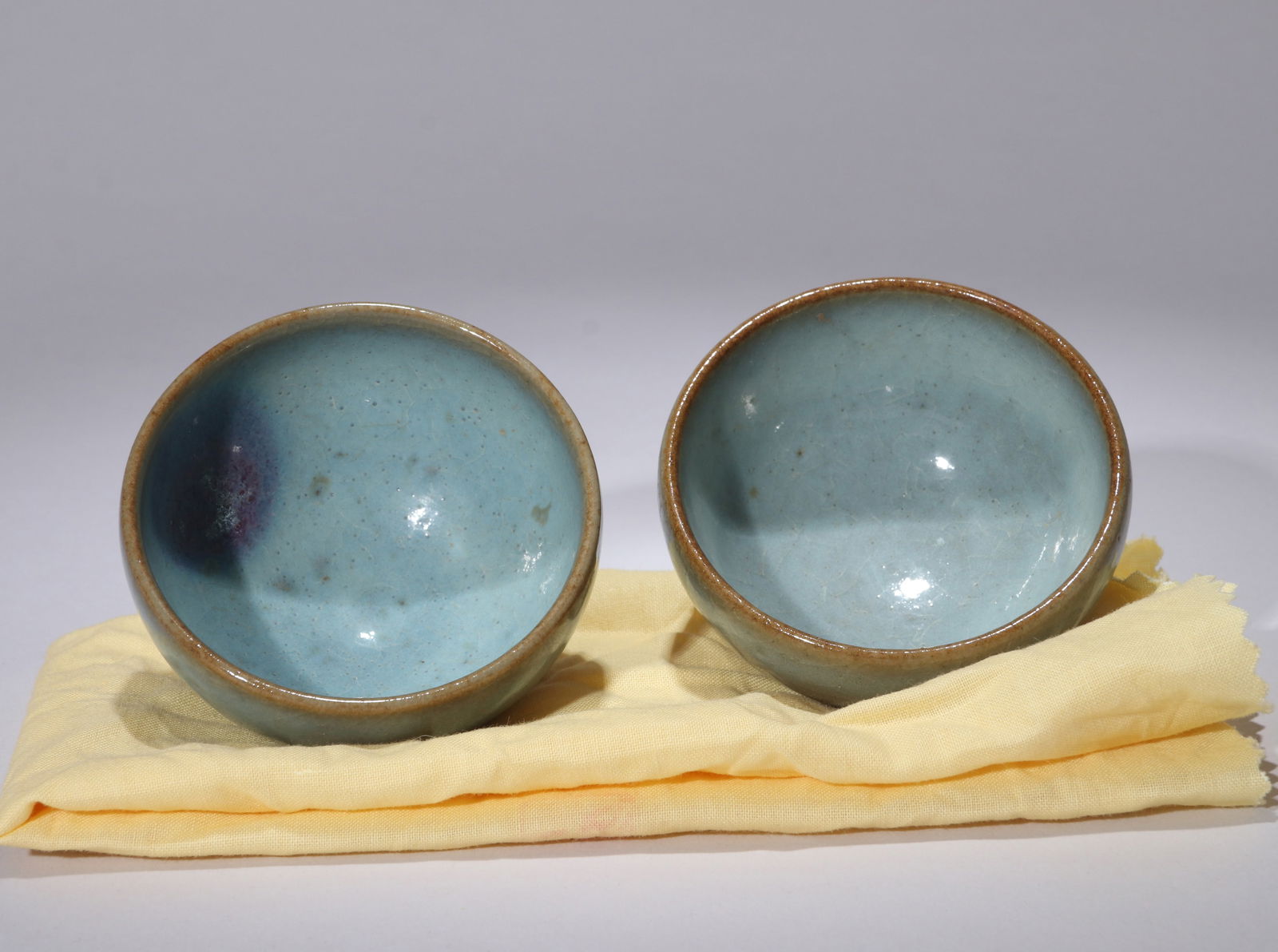 TWO JUN WARE SMALL CUPS: TWO JUN WARE SMALL CUPS Diameter: 6.5 cm (2.56 in.) x Height: 4.5 cm (1.77 in.). All measurements are approximate.