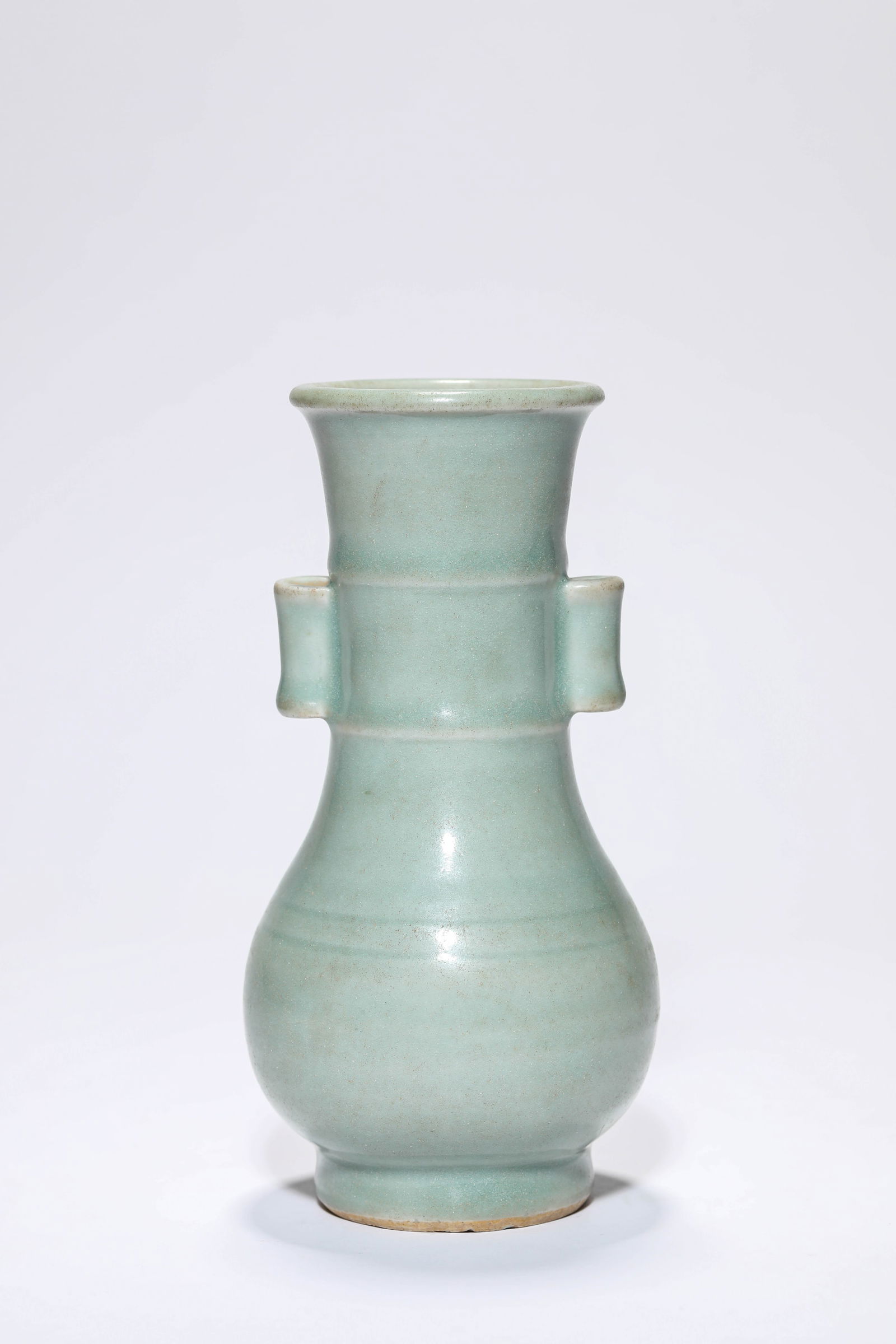 A CELADON VASE: A CELADON VASE Dimensions: Width: 8.5 cm (3.35 in.) x Height: 17.7 cm (6.97 in.). All measurements are approximate.