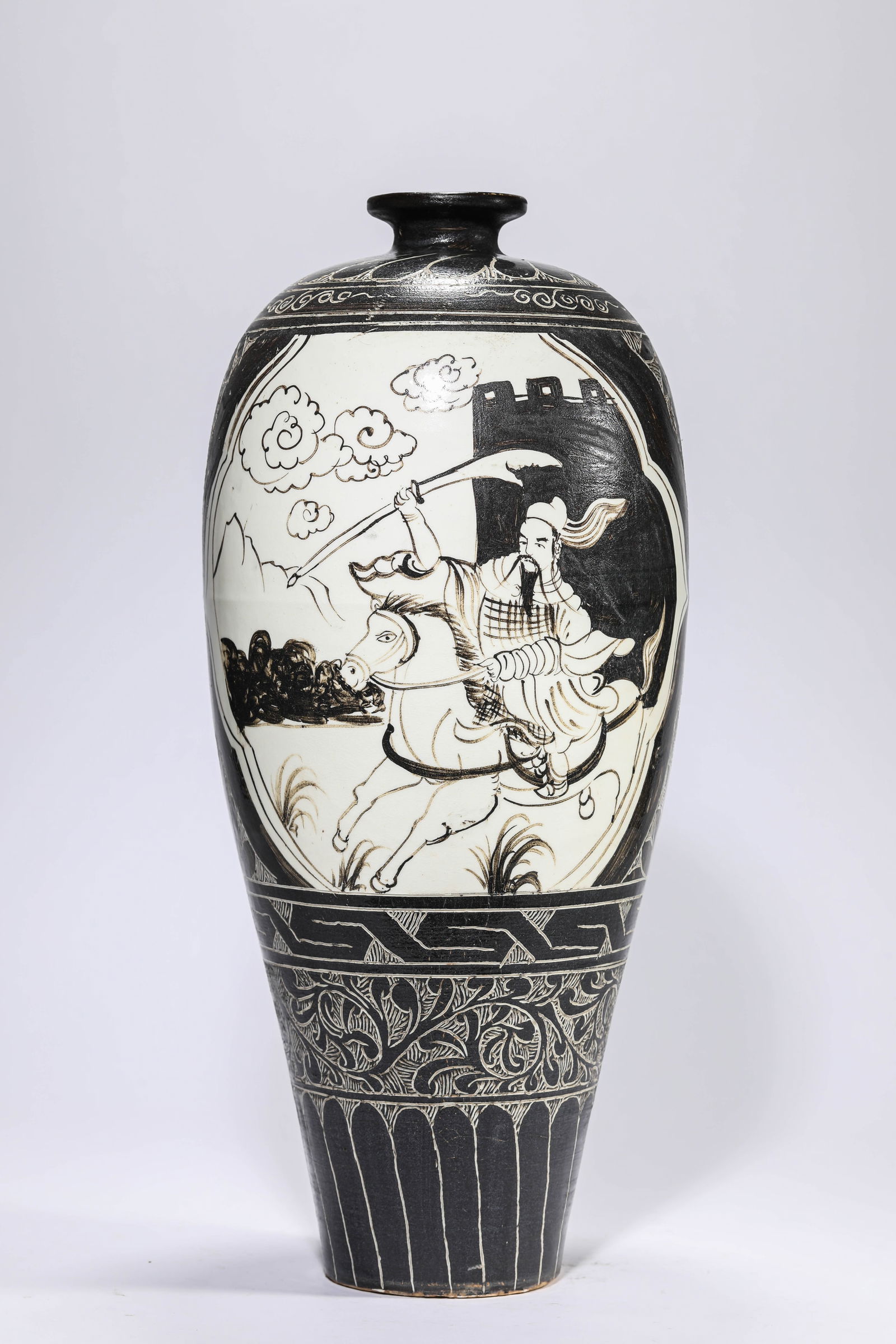 A CIZHOU-TYPE 'BLACK-GLAZED CARVED HUNTING SCENE' MEIPING: A CIZHOU-TYPE 'BLACK-GLAZED CARVED HUNTING SCENE' MEIPING Dimensions: Width: 20.2 cm (7.95 in) x Height: 44.9 cm (17.68 in). All measurements are approximate.
