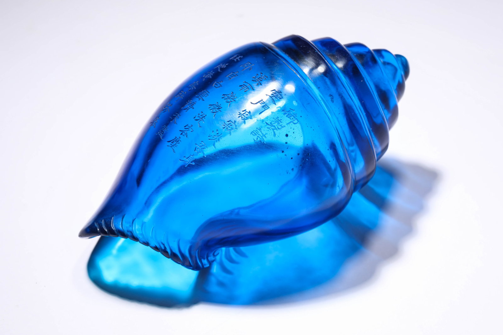 A BLUE-GLASS 'IMPERIAL POEM' CONCH SHELL (1 of 5)