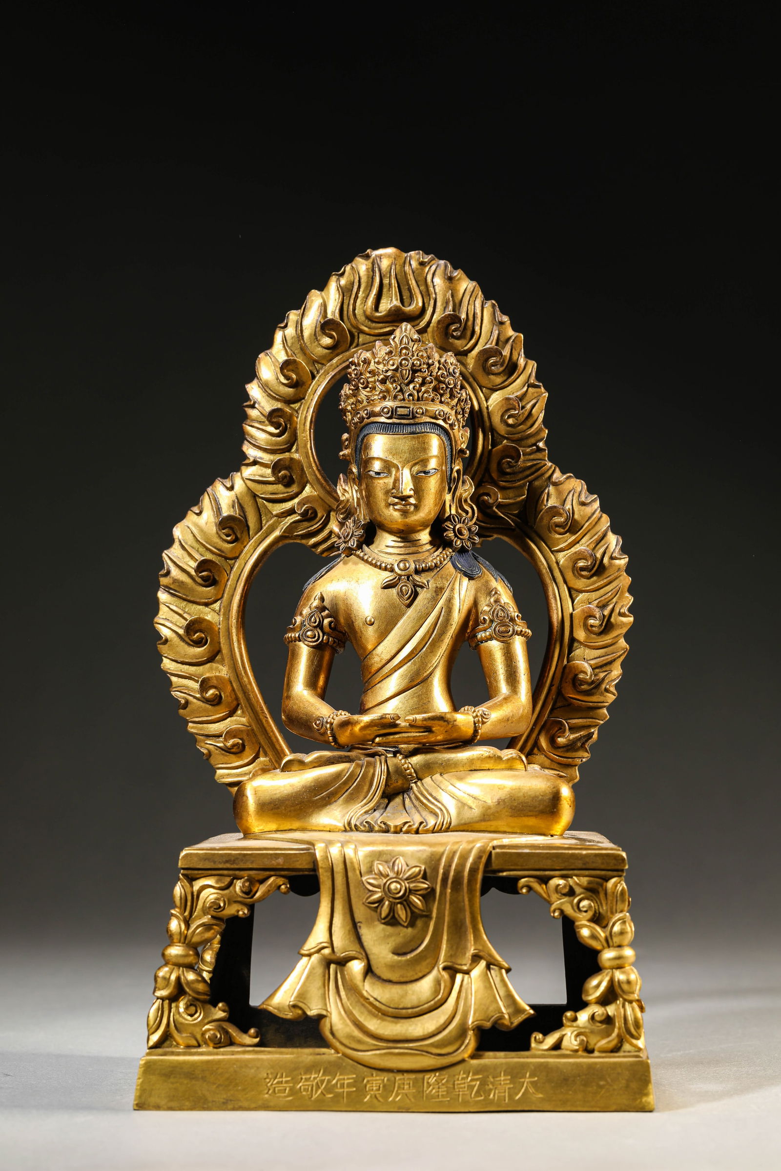 A GILT-BRONZE FIGURE OF AMITAYUS: A GILT-BRONZE FIGURE OF AMITAYUS Dimensions: Weight: 2.6kg. Length: 15.7 cm (6.18 in) x Width: 12.2 cm (4.80 in) x Height: 27.0 cm (10.63 in). All measurements are approximate.