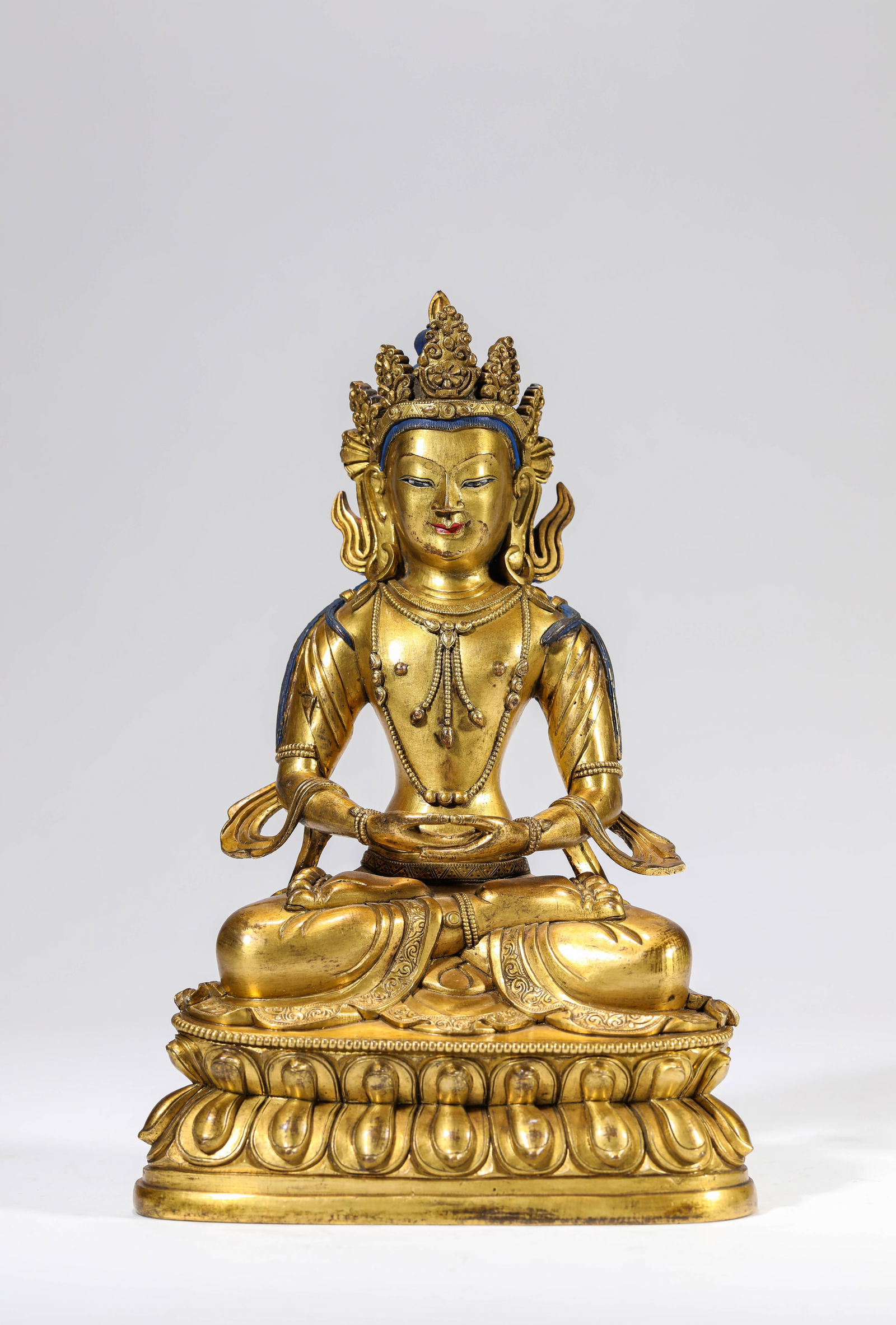 A GILT-BRONZE FIGURE OF AMITAYUS: A GILT-BRONZE FIGURE OF AMITAYUS Dimensions: Weight: 1780g. Length: 14.0 cm (5.51 in) x Width: 9.6 cm (3.78 in) x Height: 21.0 cm (8.27 in). All measurements are approximate.
