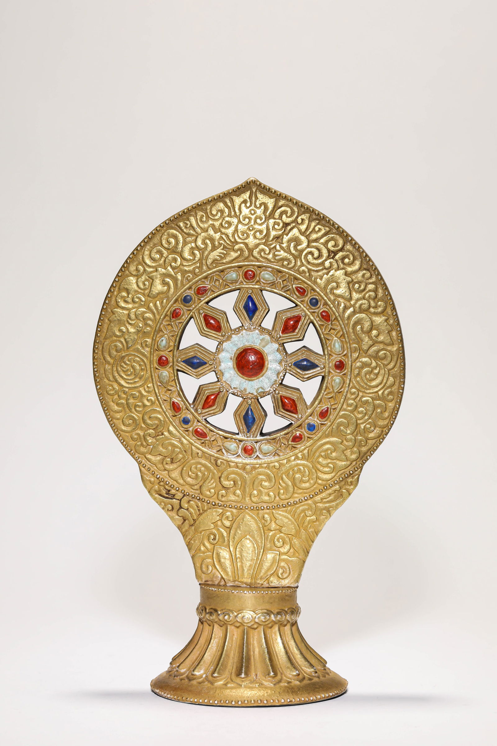 A 'GOLD-GLAZED IMITATION' DHARMA WHEEL: A 'GOLD-GLAZED IMITATION' DHARMA WHEEL Dimensions: Length: 17.0 cm (6.69 in) x Width: 10.9 cm (4.29 in) x Height: 27.5 cm (10.83 in). All measurements are approximate.