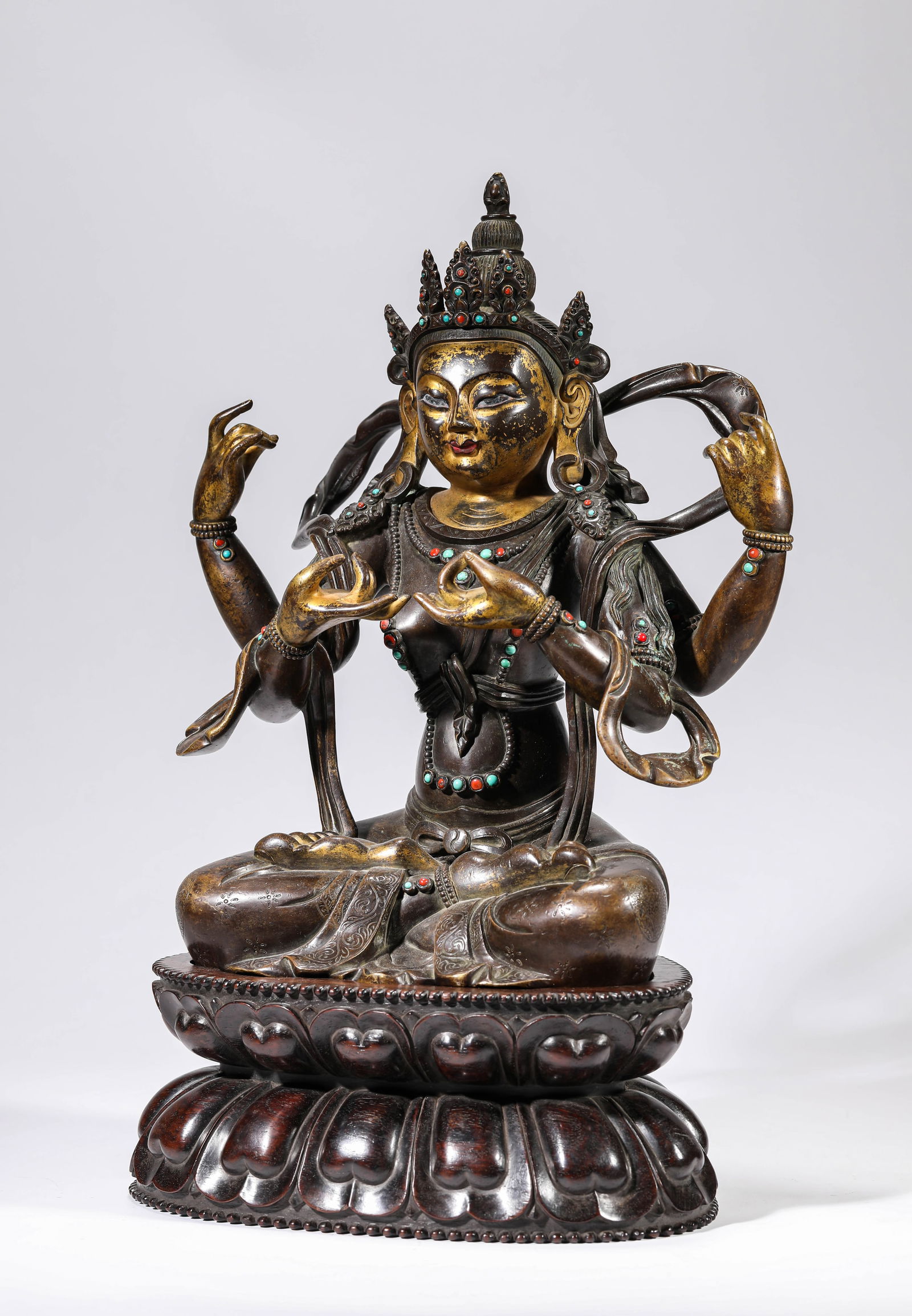 A GILT-BRONZE FIGURE OF FOUR-ARMED AVALOKITESHVARA: A GILT-BRONZE FIGURE OF FOUR-ARMED AVALOKITESHVARA Dimensions: Weight: 7.9kg. Length: 27.0 cm (10.63 in) x Width: 14.7 cm (5.79 in) x Height: 33.5 cm (13.19 in). All measurements are approximate.