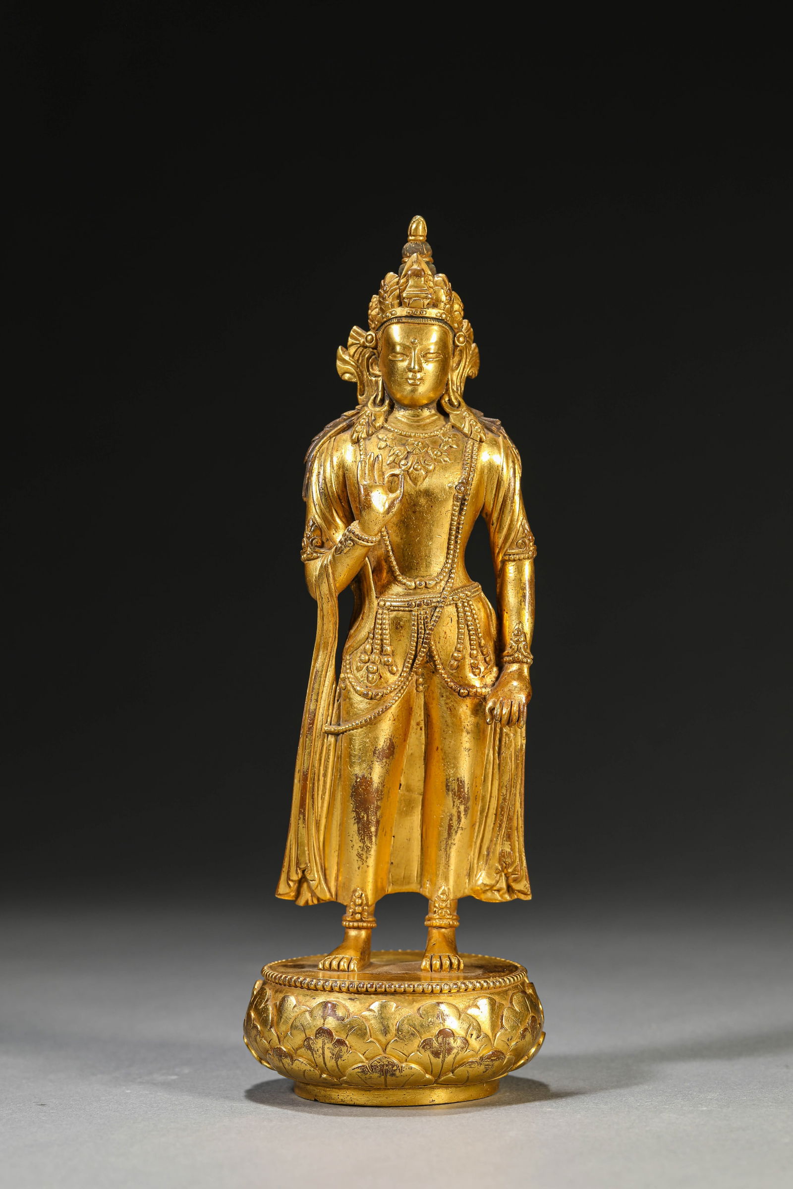 A GILT-BRONZE STANDING FIGURE OF BUDDHA: A GILT-BRONZE STANDING FIGURE OF BUDDHA Dimensions: Weight: 767g. Width: 7.0 cm (2.76 in) x Height: 20.7 cm (8.15 in). All measurements are approximate.