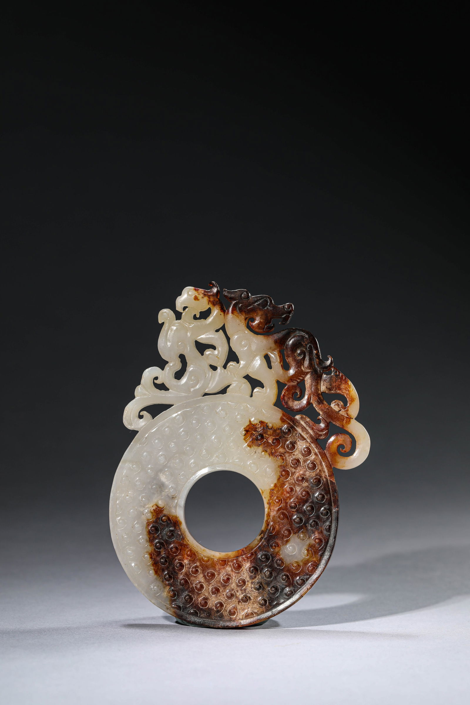 A JADE 'OPENWORK DRAGON AND PHOENIX' BI DISC: A JADE 'OPENWORK DRAGON AND PHOENIX' BI DISC Dimensions: Length: 12.5 cm (4.92 in) x Width: 9.2 cm (3.62 in). All measurements are approximate.