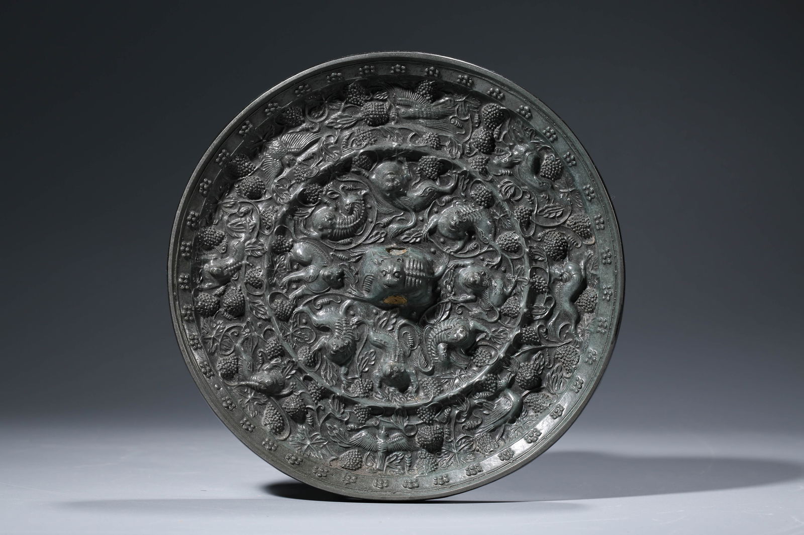A BRONZE 'SEA CREATURES AND GRAPES' MIRROR: A BRONZE 'SEA CREATURES AND GRAPES' MIRROR Dimensions: Weight: 2075g. Width: 22.2 cm (8.74 in) x Height: 2.3 cm (0.91 in). All measurements are approximate.