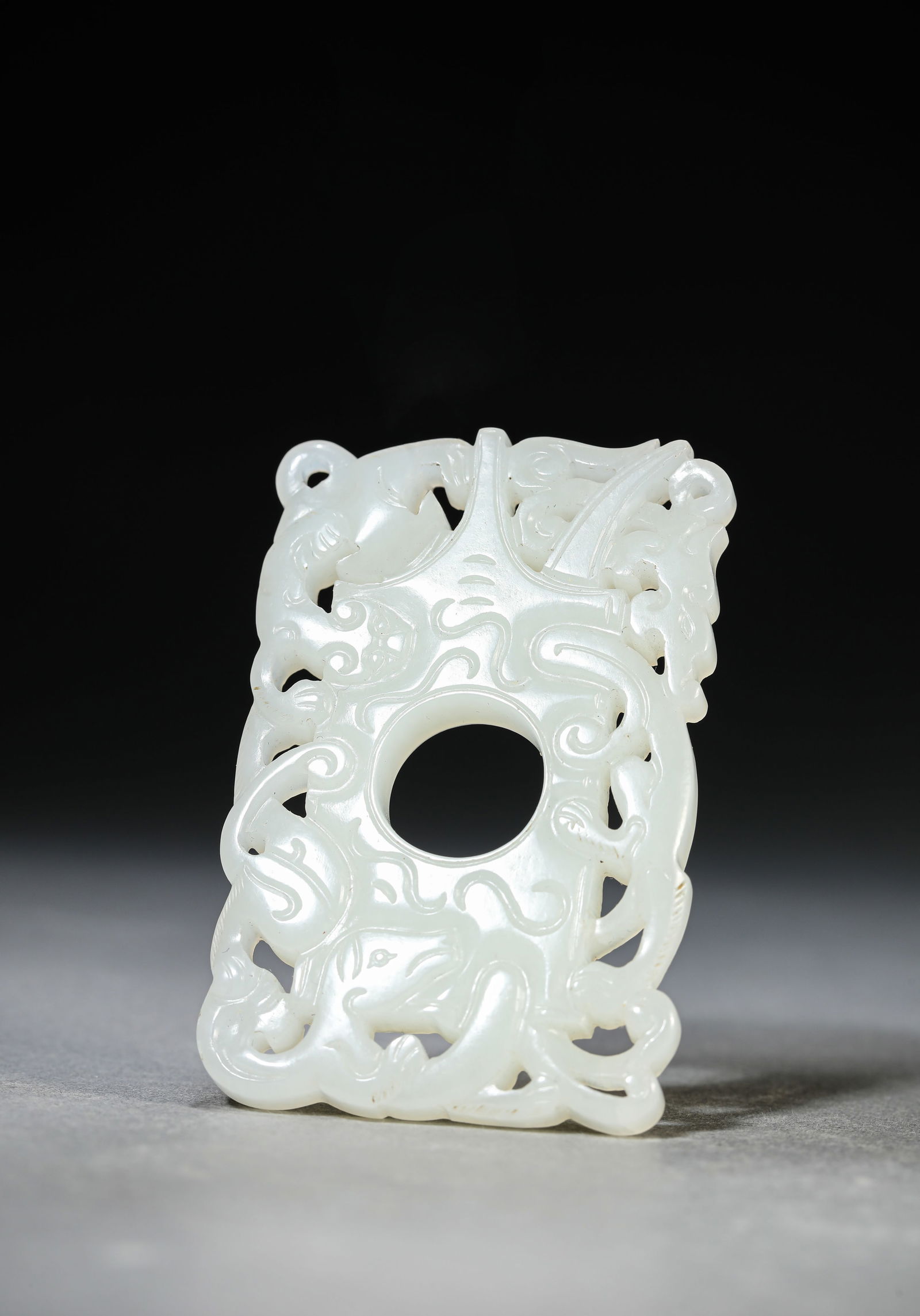 A JADE 'CHI-DRAGON' PENDANT: A JADE 'CHI-DRAGON' PENDANT Dimensions: Width: 4.6 cm (1.81 in) x Height: 7.0 cm (2.76 in). All measurements are approximate.