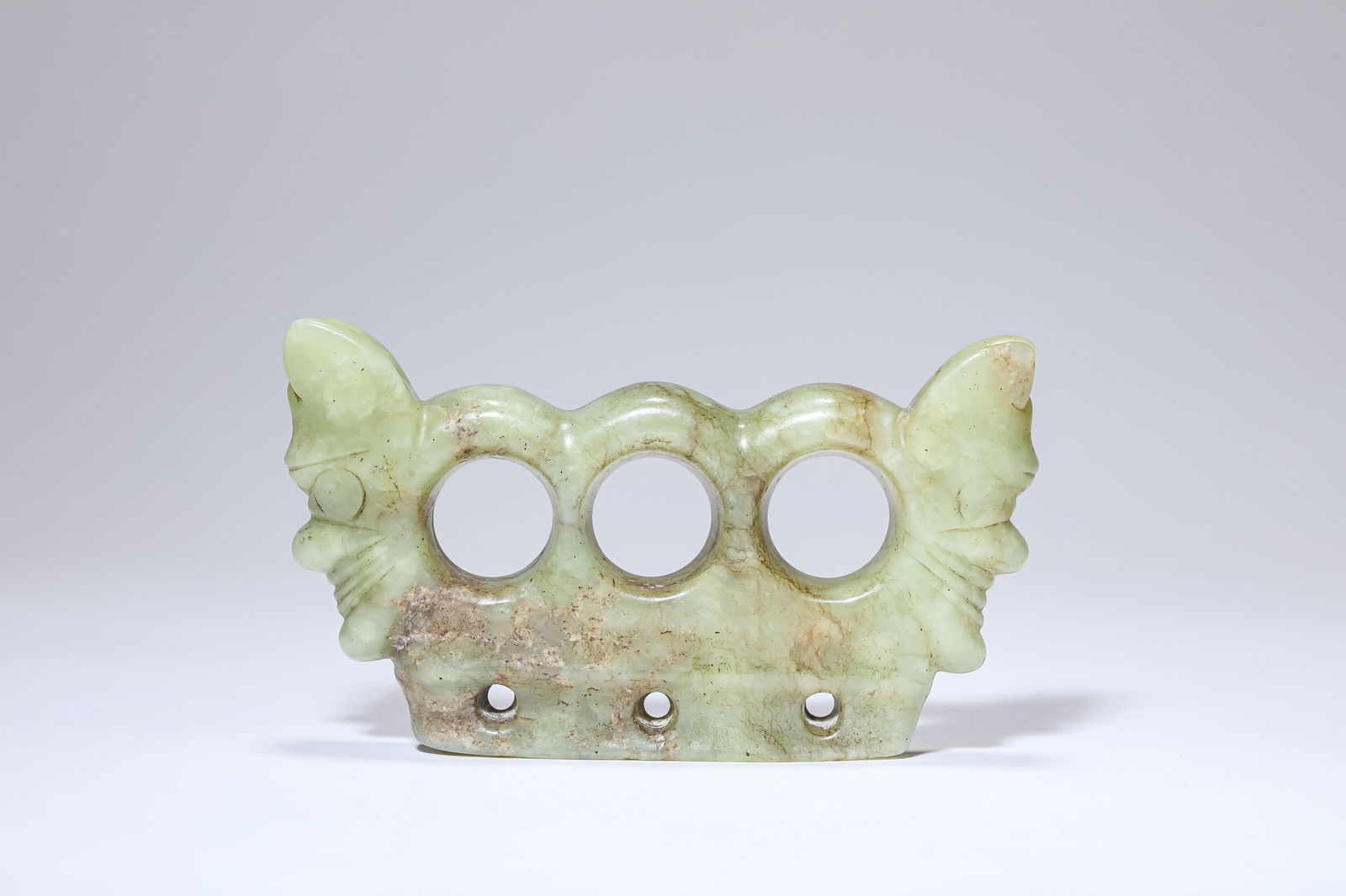 A JADE 'THREE-HOLED' OBJECT: A JADE 'THREE-HOLED' OBJECT Dimensions: Length: 10.6 cm (4.17 in) x Width: 2.0 cm (0.79 in) x Height: 6.7 cm (2.64 in). All measurements are approximate.
