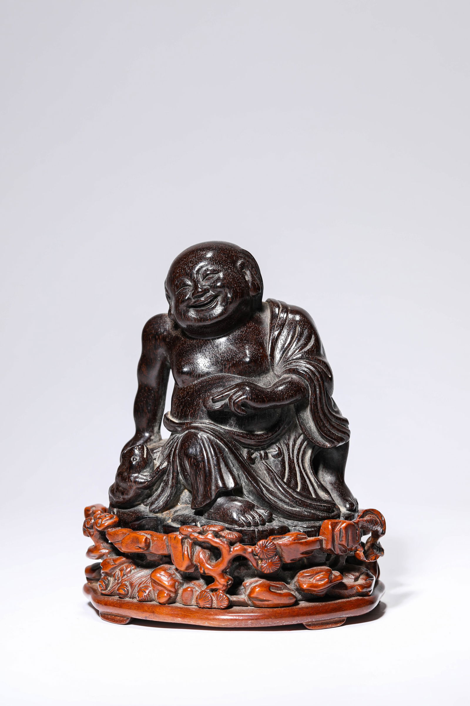 A WOOD 'CARVED LIU HAI PLAYING WITH A TOAD': A WOOD 'CARVED LIU HAI PLAYING WITH A TOAD' Dimensions: Length: 10.0 cm (3.94 in) x Width: 8.9 cm (3.50 in) x Height: 11.4 cm (4.49 in). All measurements are approximate.