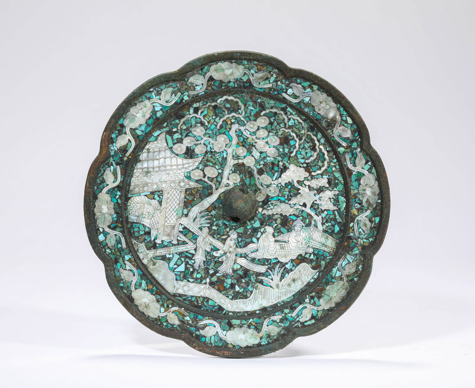 A MOTHER-OF-PEARL AND TURQUOISE-INLAID BRONZE MIRROR: A MOTHER-OF-PEARL AND TURQUOISE-INLAID BRONZE MIRROR Dimensions: Weight: 1220g. Width: 22.5 cm (8.86 in). All measurements are approximate.