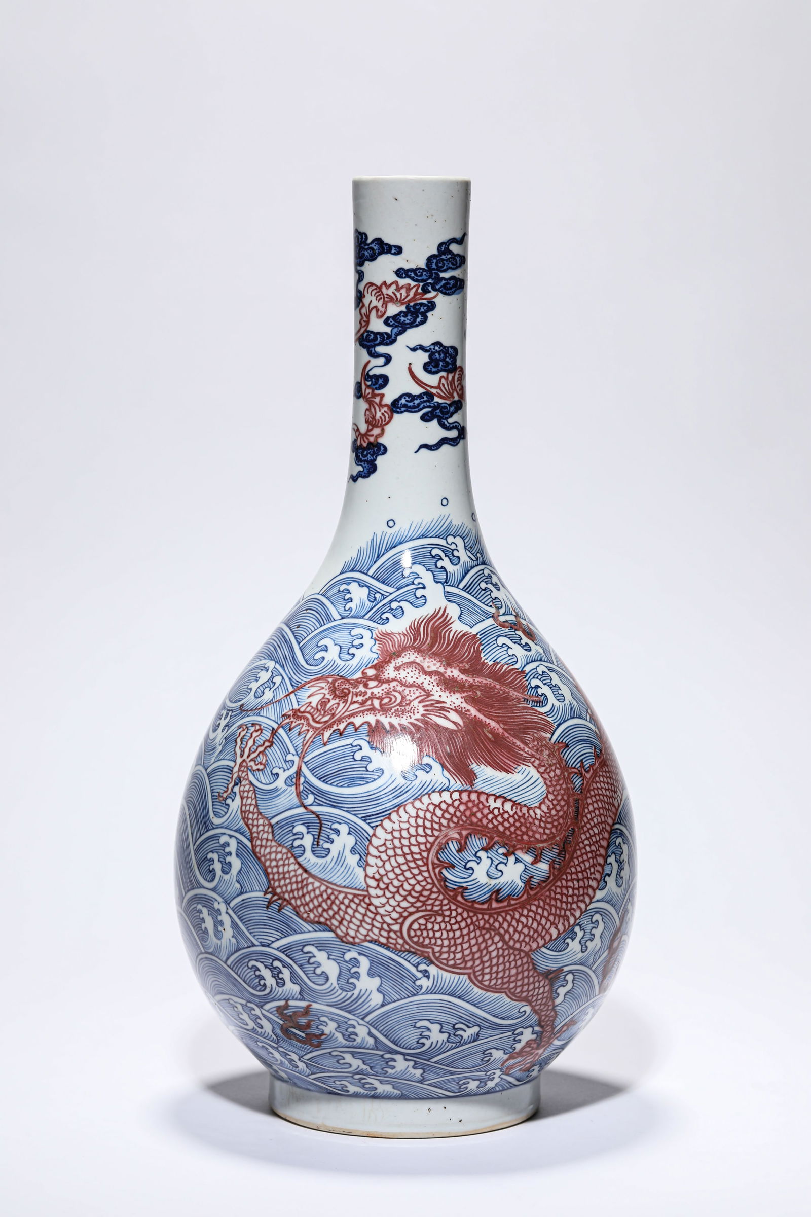 A BLUE AND WHITE AND UNDERGLAZE-RED 'DRAGON AMIDST WAVES' VASE: A BLUE AND WHITE AND UNDERGLAZE-RED 'DRAGON AMIDST WAVES' VASE Dimensions: Width: 19.0 cm (7.48 in) x Height: 38.5 cm (15.16 in). All measurements are approximate.