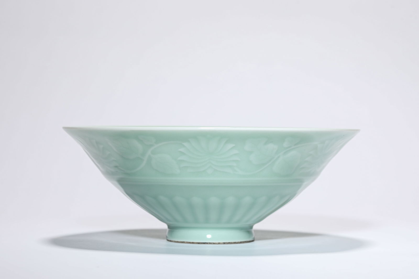 A BEAN-GREEN-GLAZED 'FLORAL' CUP: A BEAN-GREEN-GLAZED 'FLORAL' CUP Dimensions: Width: 21.5 cm (8.46 in) x Height: 8.0 cm (3.15 in). All measurements are approximate.
