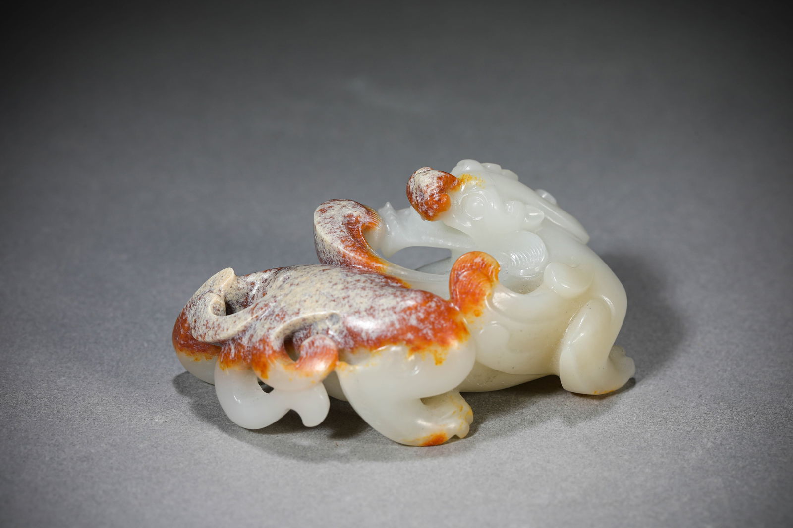 A JADE 'AUSPICIOUS BEAST' ORNAMENT: A JADE 'AUSPICIOUS BEAST' ORNAMENT Dimensions: Length: 7.0 cm (2.76 in) x Width: 4.1 cm (1.61 in) x Height: 3.7 cm (1.46 in). All measurements are approximate.