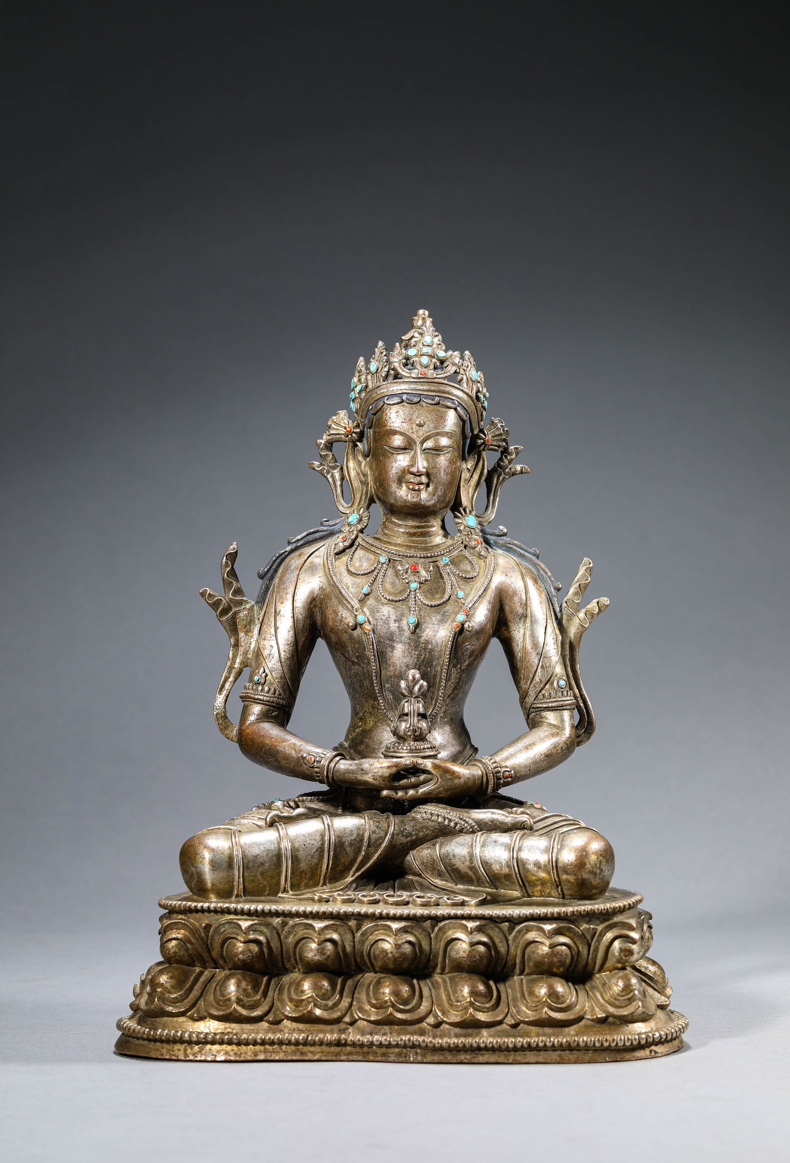 A SILVER-PLATED FIGURE OF AMITAYUS: A SILVER-PLATED FIGURE OF AMITAYUS Dimensions: Weight: 4kg. Length: 20.2 cm (7.95 in) x Width: 14.7 cm (5.79 in) x Height: 28.7 cm (11.30 in). All measurements are approximate.