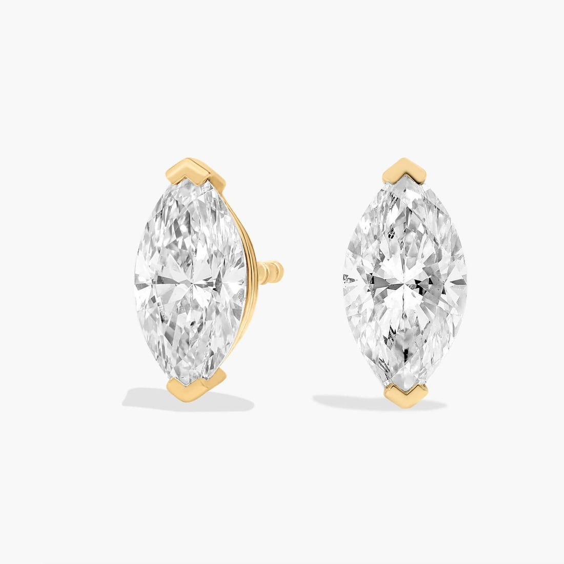 MARQUISE CUT DIAMOND STUD EARRINGS IN 14K YELLOW GOLD: MARQUISE CUT DIAMOND STUD EARRINGS IN 14K YELLOW GOLD Description: Sparkle with every movement of your head when you wear these classic stud earrings set with marquise-cut diamonds. The 14k yellow gol