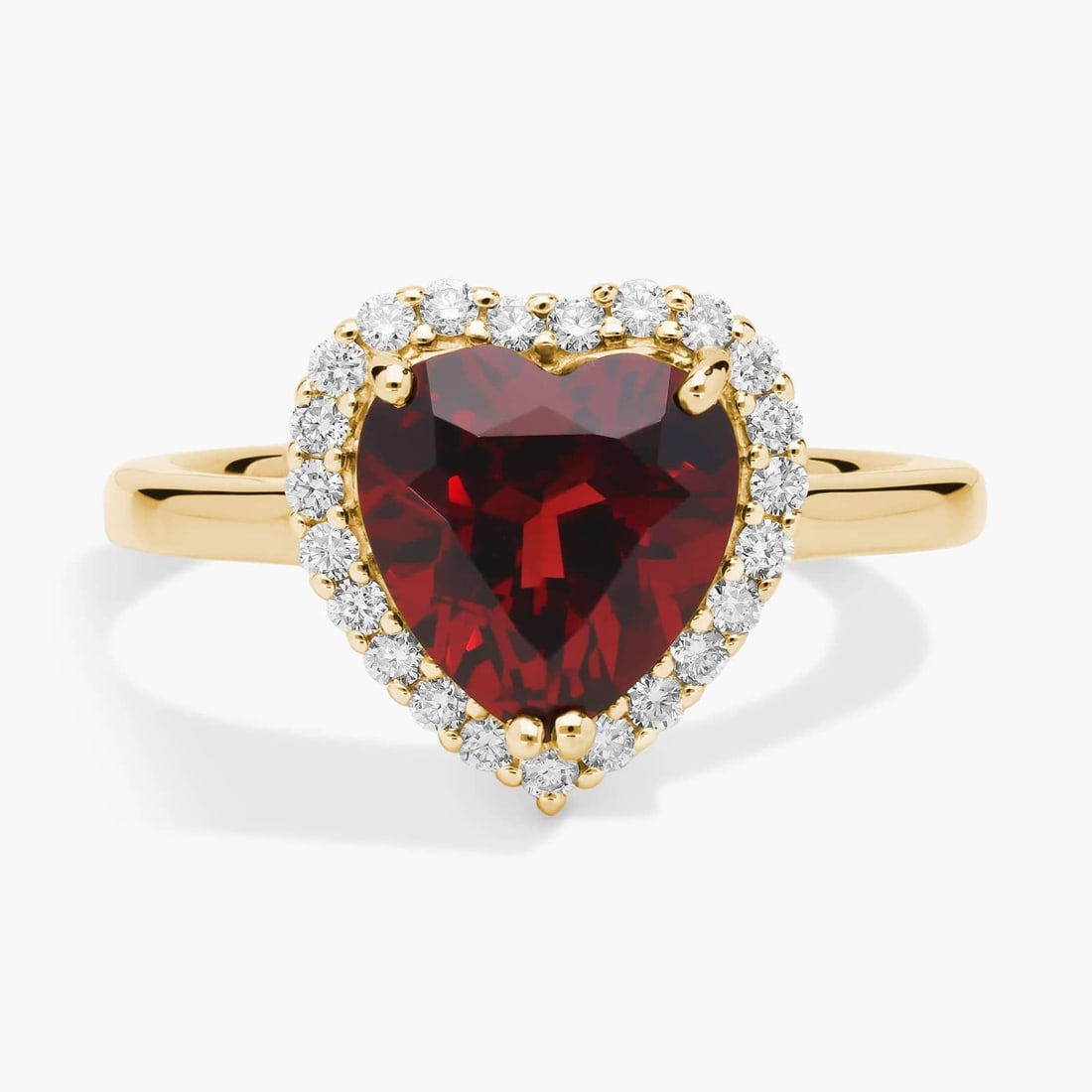 HEART SHAPED GARNET AND DIAMOND HALO RING IN 14K YELLOW GOLD: HEART SHAPED GARNET AND DIAMOND HALO RING IN 14K YELLOW GOLD Description: Lend a hint of romance to your look as you slip on this ring featuring a gorgeously hued heart-shaped garnet. A shimmering hal