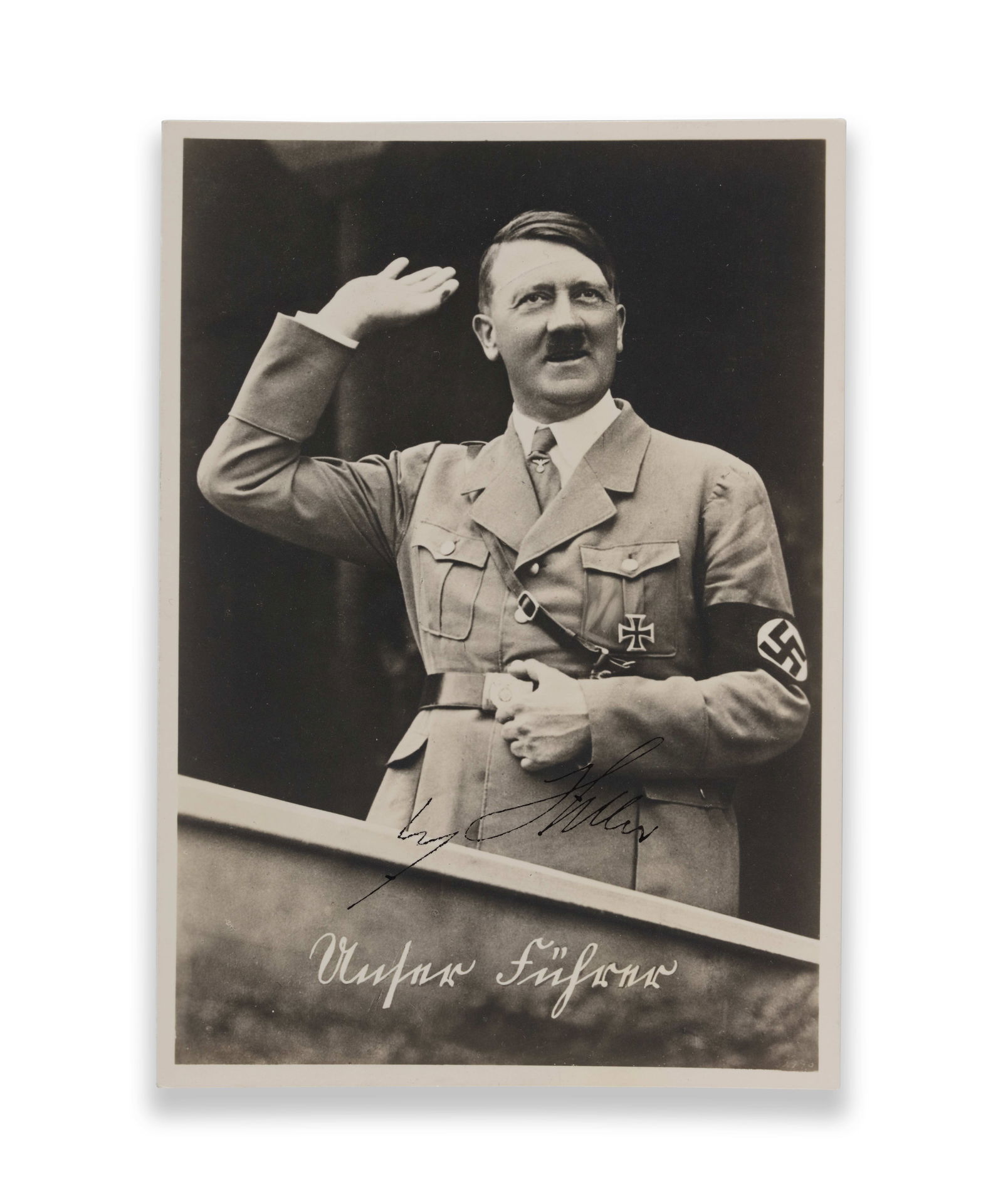 ADOLF HITLER - SIGNED SILVER GELATIN PHOTOGRAPHIC POSTCARD ("UNSER FÜHRER"), NUREMBERG CANCEL: ADOLF HITLER - SIGNED SILVER GELATIN PHOTOGRAPHIC POSTCARD ("UNSER FÜHRER"), NUREMBERG CANCEL Provenance and Authenticity: This item includes a certificate of authenticity. This silver gelatin photog