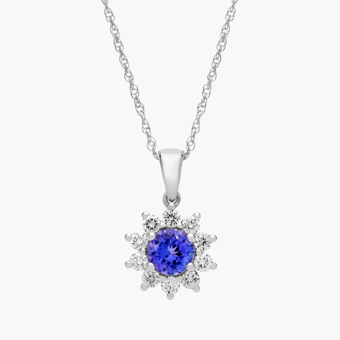 ROUND TANZANITE AND DIAMOND HALO PENDANT NECKLACE IN 14K WHITE GOLD (6MM): ROUND TANZANITE AND DIAMOND HALO PENDANT NECKLACE IN 14K WHITE GOLD (6MM)Description:A stylish round tanzanite gets added sparkle from a halo of diamonds in this 14k gold necklace. Add some color to