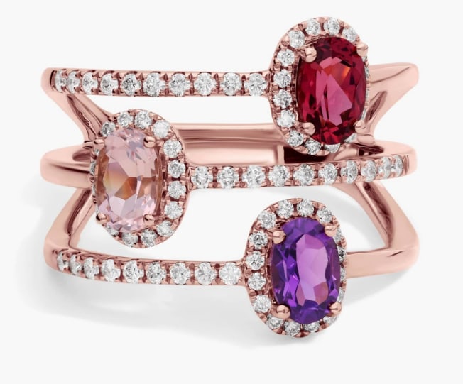 THREE STONE FAUX STACKING RING IN 14K ROSE GOLD: THREE STONE FAUX STACKING RING IN 14K ROSE GOLD Description: This ring features amethyst, morganite and rhodolite garnet gemstones that sparkle in a split design that splays it into the appearance of