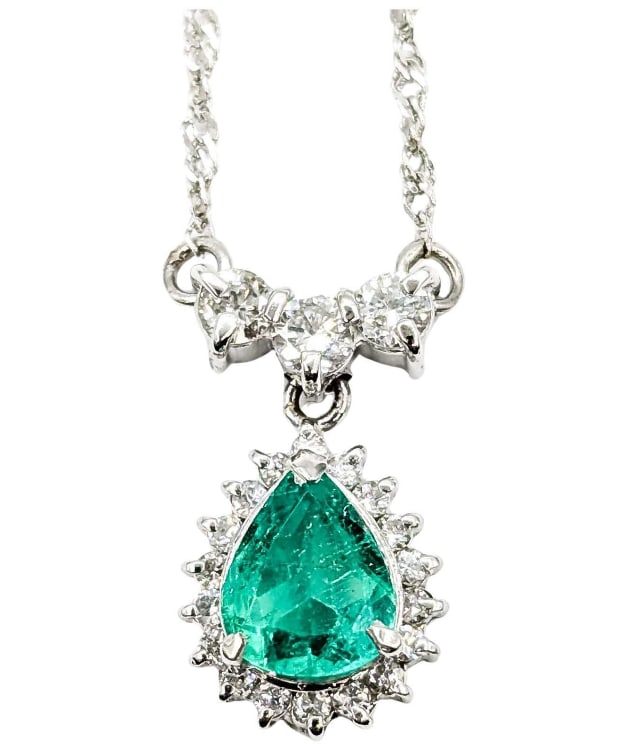 ELEGANT PLATINUM EMERALD & DIAMOND DROP NECKLACE: ELEGANT PLATINUM EMERALD & DIAMOND DROP NECKLACEDescription:This elegant vintage necklace is crafted in 850 platinum and features a vibrant pear-cut emerald weighing .70 carats. The emerald is