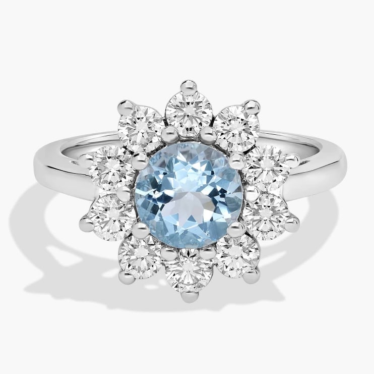 ROUND AQUAMARINE AND DIAMOND HALO RING IN 14K WHITE GOLD: ROUND AQUAMARINE AND DIAMOND HALO RING IN 14K WHITE GOLD Description: This aquamarine and diamond halo ring combines a colorful center gemstone with the brilliance of diamonds. Add this sparkling ring