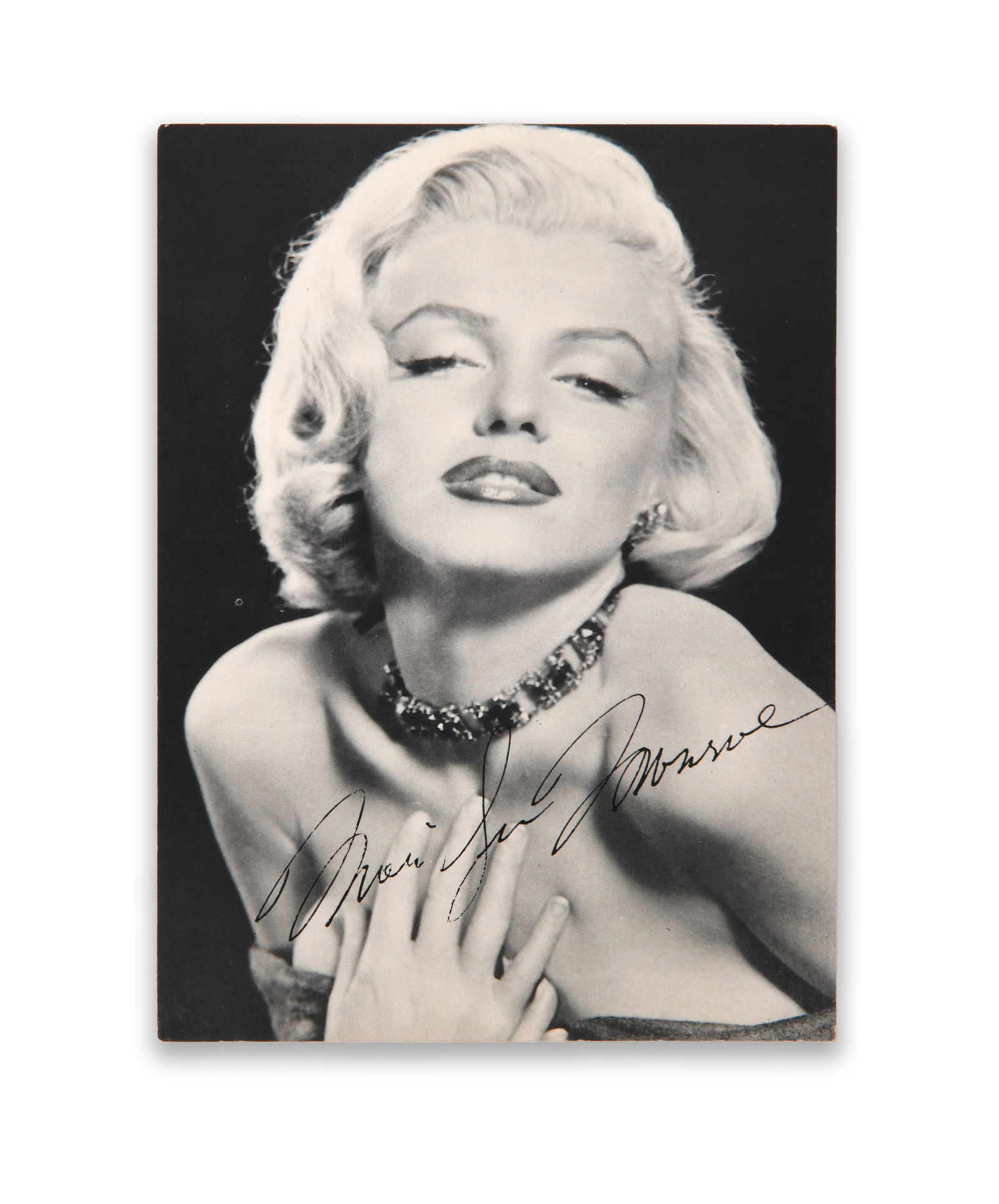 MARILYN MONROE (1926–1962), SIGNED PHOTOGRAPH POSTCARD, CIRCA 1950S: MARILYN MONROE (1926–1962), SIGNED PHOTOGRAPH POSTCARD, CIRCA 1950S Provenance and Authenticity: This item includes a certificate of authenticity. This black-and-white glamour portrait of Marilyn Mo