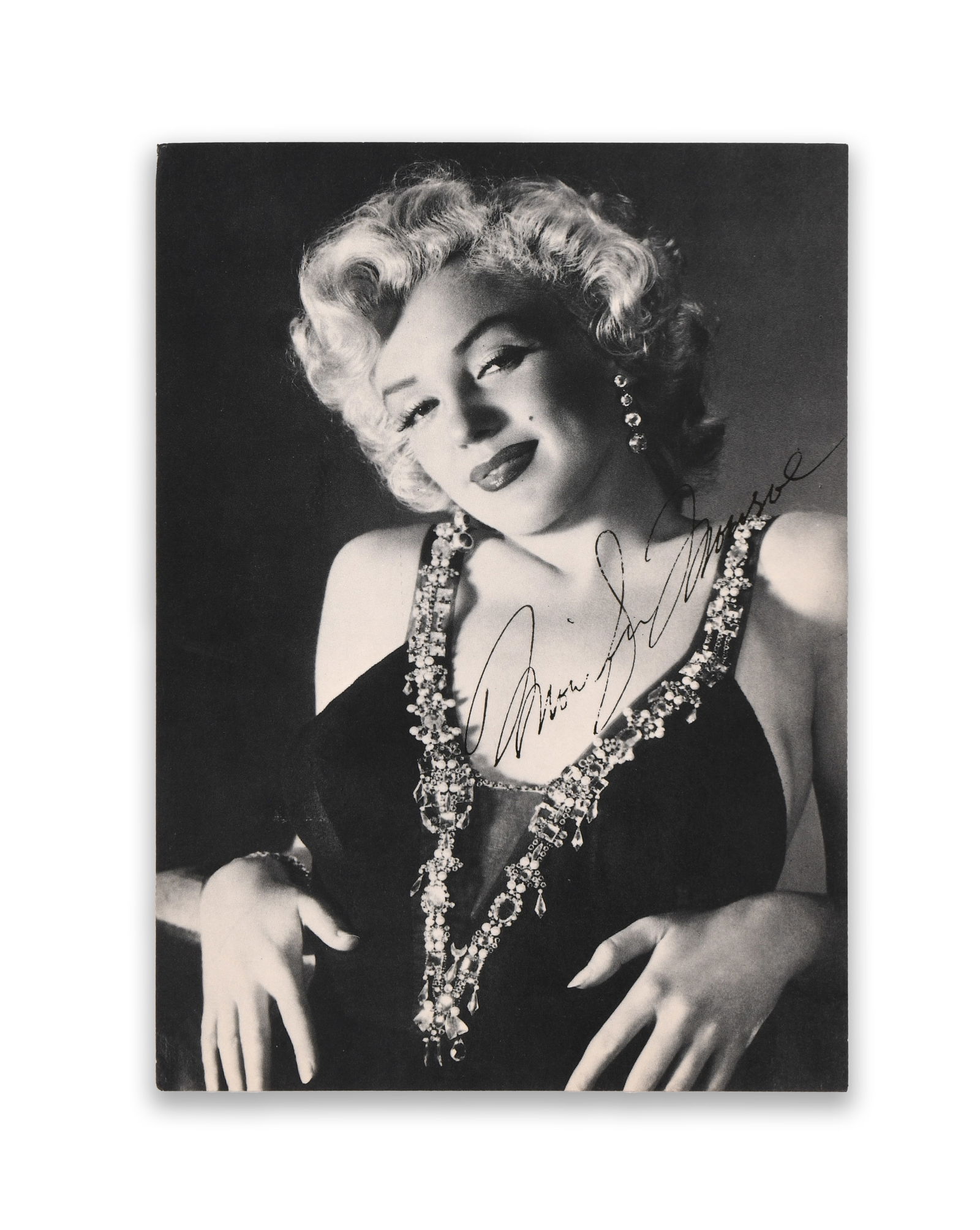MARILYN MONROE (1926–1962), SIGNED PHOTOGRAPH POSTCARD, CIRCA 1950S: MARILYN MONROE (1926–1962), SIGNED PHOTOGRAPH POSTCARD, CIRCA 1950S Provenance and Authenticity: This item includes a certificate of authenticity. This black-and-white glamour portrait of Marilyn Mo