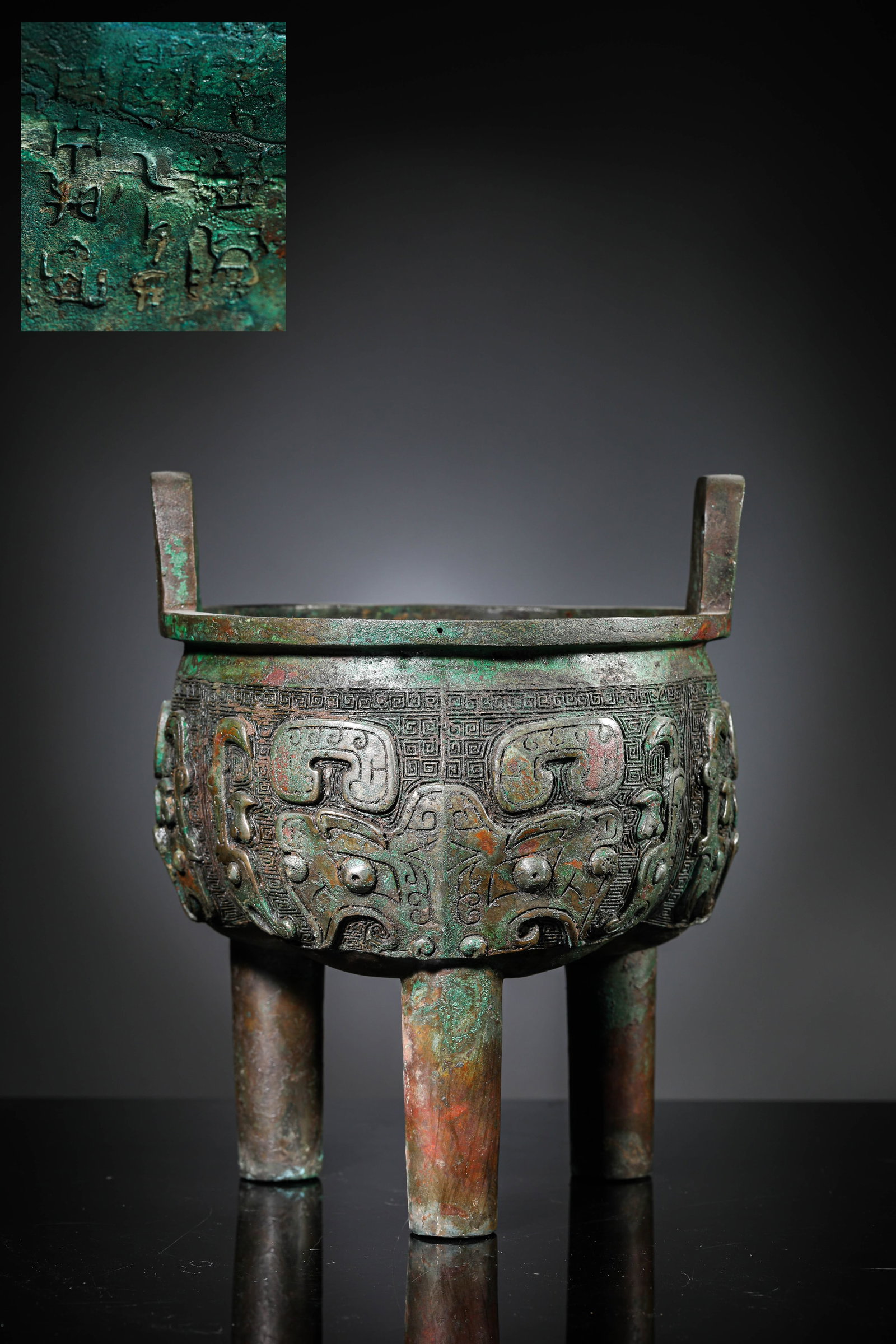 A BRONZE 'ANIMAL MASK' TRIPOD 'DING': A BRONZE 'ANIMAL MASK' TRIPOD 'DING' Dimensions: Weight: 2.65kg. Width: 18.4 cm (7.24 in) x Height: 23.8 cm (9.37 in). All measurements are approximate.