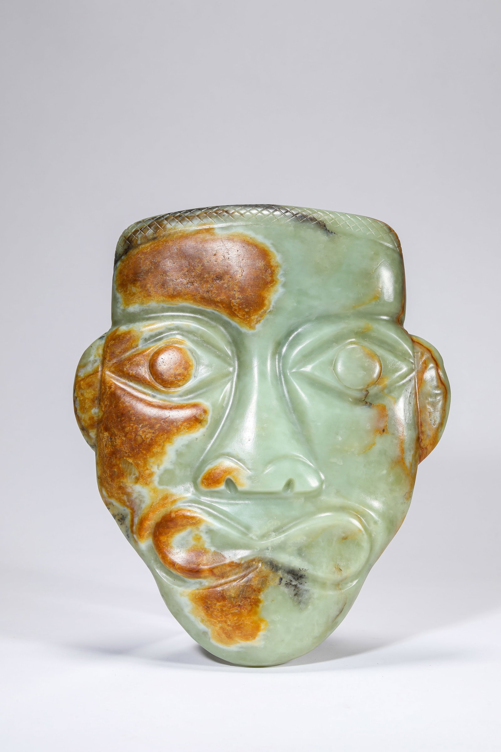 A JADE MASK: A JADE MASK Dimensions: Width: 17.5 cm (6.89 in) x Height: 21.3 cm (8.39 in). All measurements are approximate.