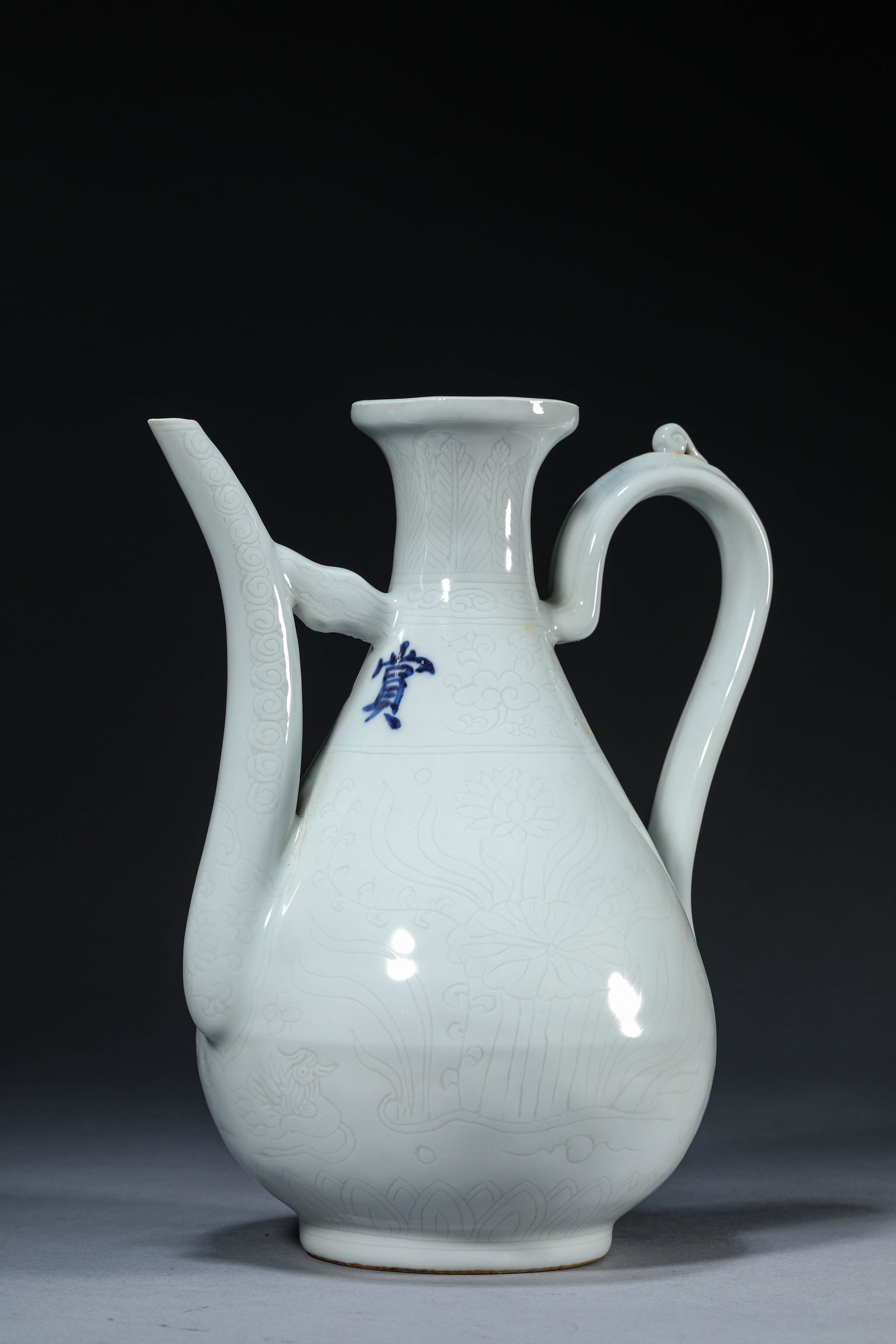 A WHITE-GLAZED 'FLOWERS AND BIRDS' EWER: A WHITE-GLAZED 'FLOWERS AND BIRDS' EWER Dimensions: Length: 21.0 cm (8.27 in) x Width: 15.4 cm (6.06 in) x Height: 26.0 cm (10.24 in). All measurements are approximate.