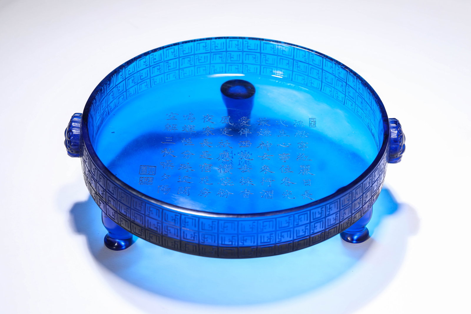 A BLUE-GLASS 'IMPERIAL POEM' BRUSH WASHER: A BLUE-GLASS 'IMPERIAL POEM' BRUSH WASHER Dimensions: Length: 24.0 cm (9.45 in) x Width: 22.0 cm (8.66 in) x Height: 7.0 cm (2.76 in). All measurements are approximate.