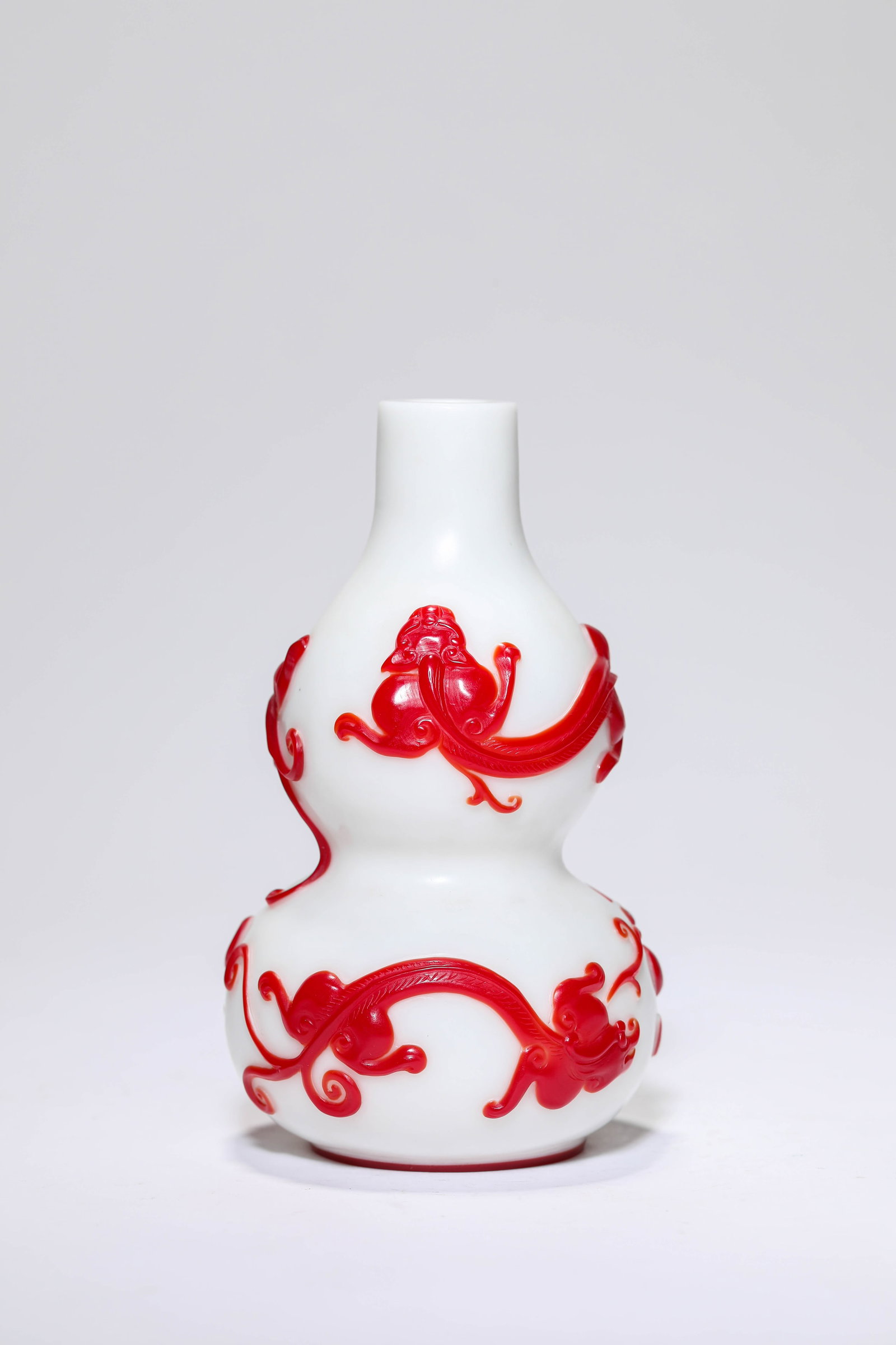 A OVERLAY RED-GLASS 'DOUBLE-GOURD' VASE: A OVERLAY RED-GLASS 'DOUBLE-GOURD' VASE Dimensions: Width: 7.7 cm (3.03 in) x Height: 12.6 cm (4.96 in). All measurements are approximate.