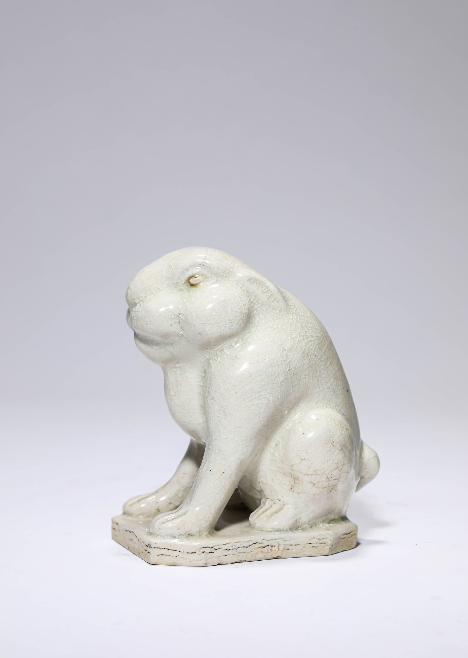A WHITE PORCELAIN RABBIT: A WHITE PORCELAIN RABBIT Dimensions: Length: 9.3 cm (3.66 in) x Width: 6.6 cm (2.60 in) x Height: 10.8 cm (4.25 in). All measurements are approximate.