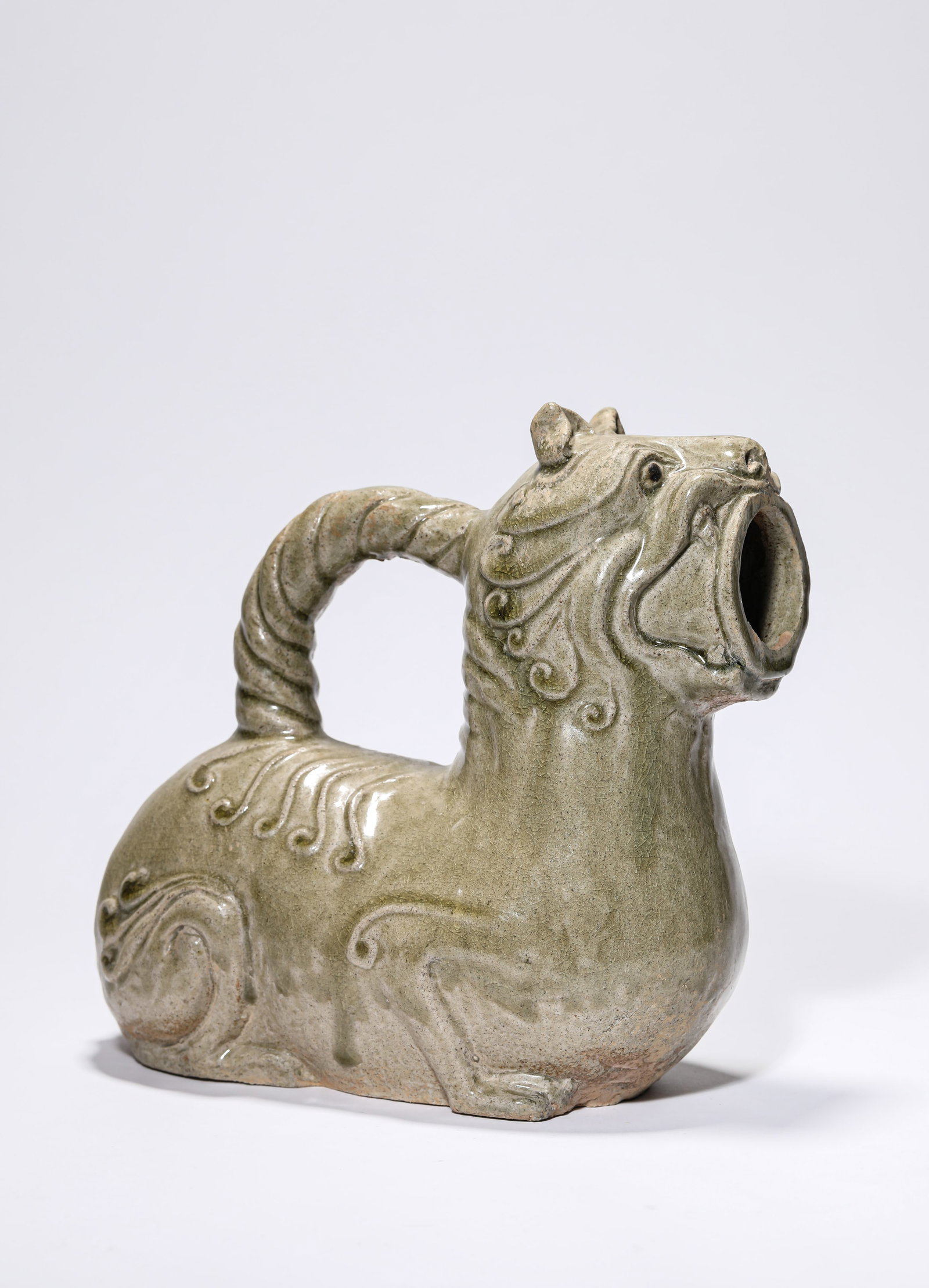 A CELADON 'HU' CHAMBER POT: A CELADON 'HU' CHAMBER POT Dimensions: Length: 23.7 cm (9.33 in) x Width: 12.0 cm (4.72 in) x Height: 21.8 cm (8.58 in). All measurements are approximate.