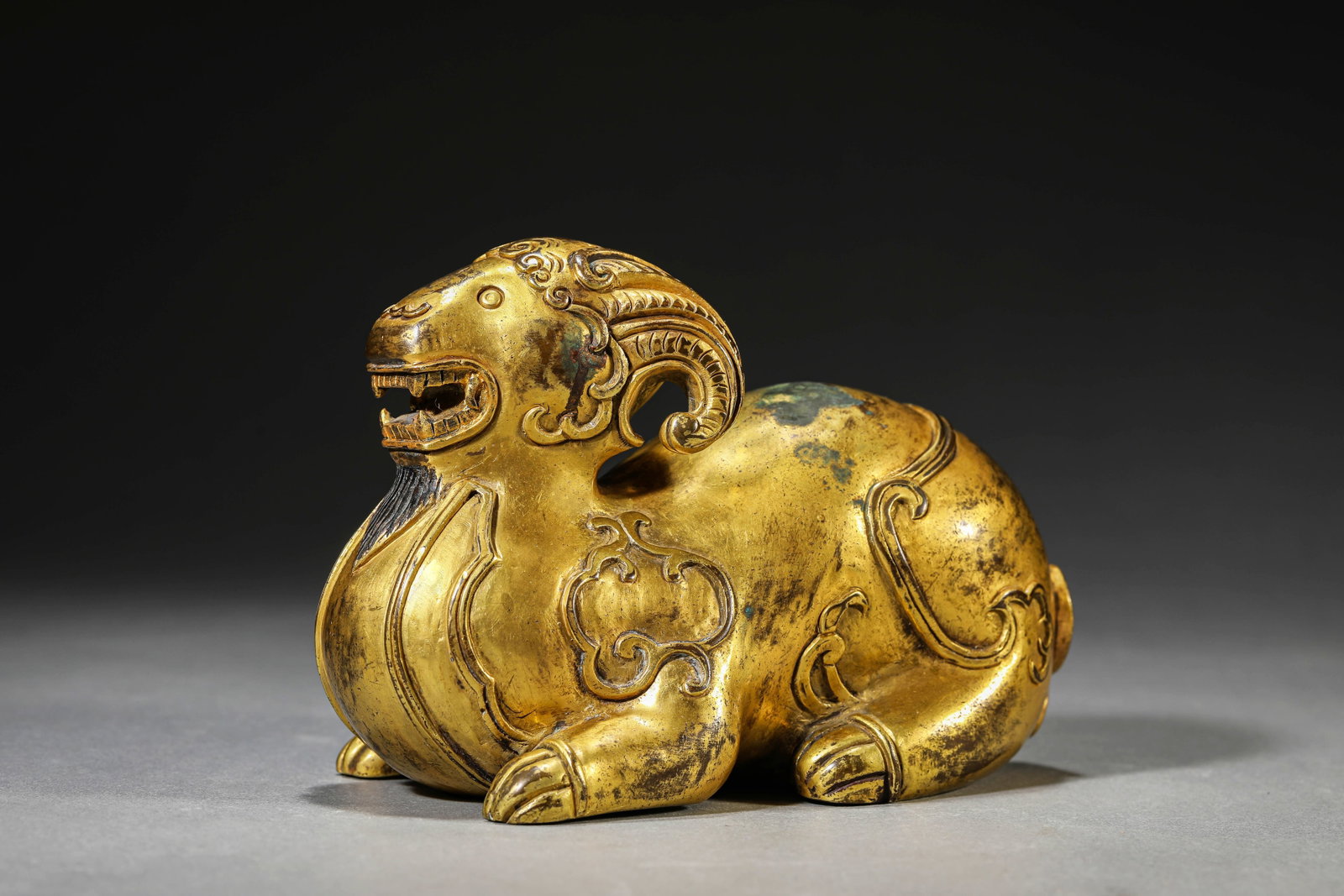 A GILT-BRONZE RAM: A GILT-BRONZE RAM Dimensions: Weight: 2600g. Length: 17.2 cm (6.77 in) x Width: 9.1 cm (3.58 in) x Height: 11.7 cm (4.61 in). All measurements are approximate.