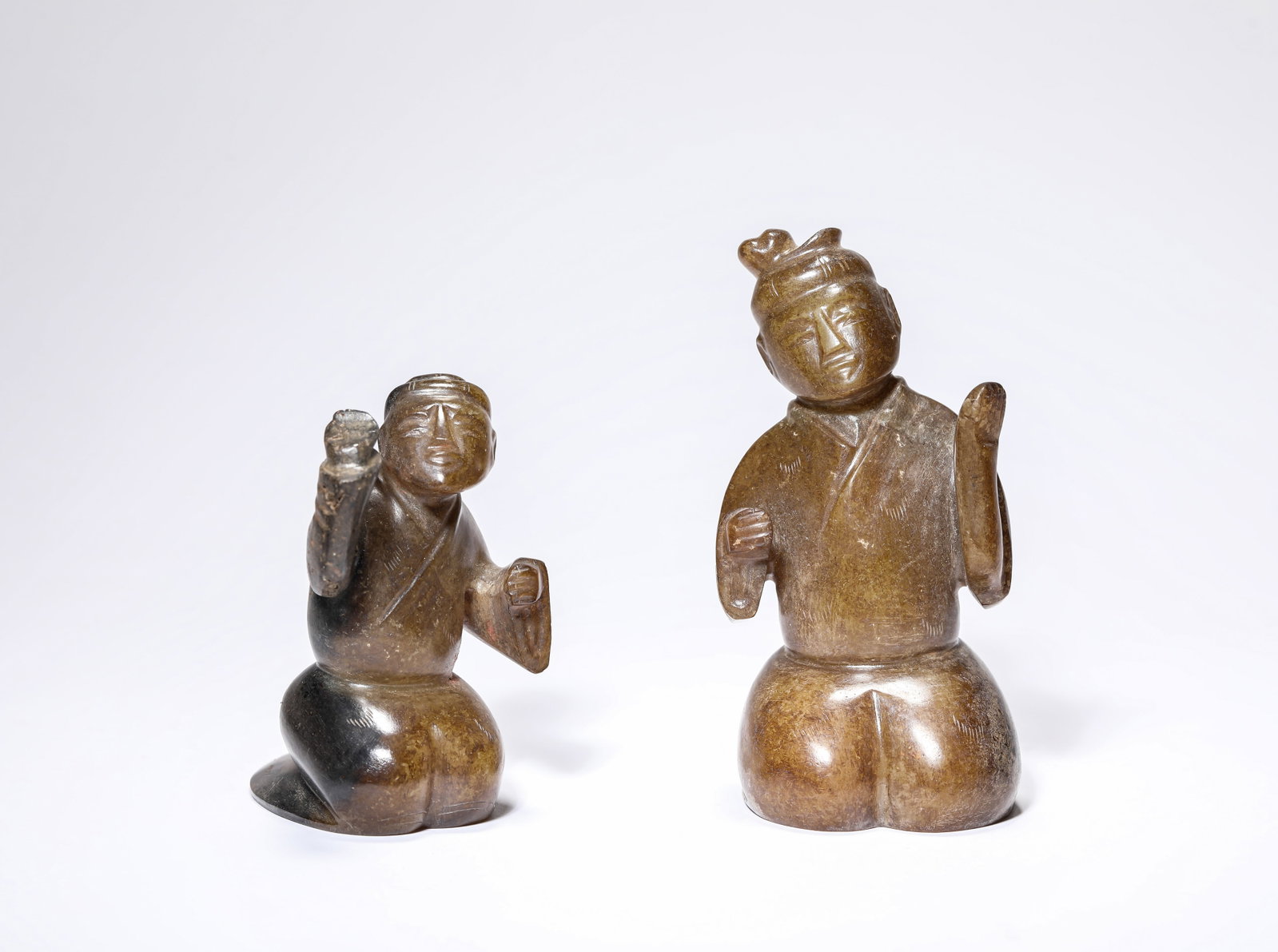 A GROUP OF JADE 'KNEELING FIGURES': A GROUP OF JADE 'KNEELING FIGURES' Dimensions: Length: 5.3 cm (2.09 in) x Width: 4.8 cm (1.89 in) x Height: 10.4 cm (4.09 in). Length: 5.0 cm (1.97 in) x Width: 6.0 cm (2.36 in) x Height: 7.9 cm